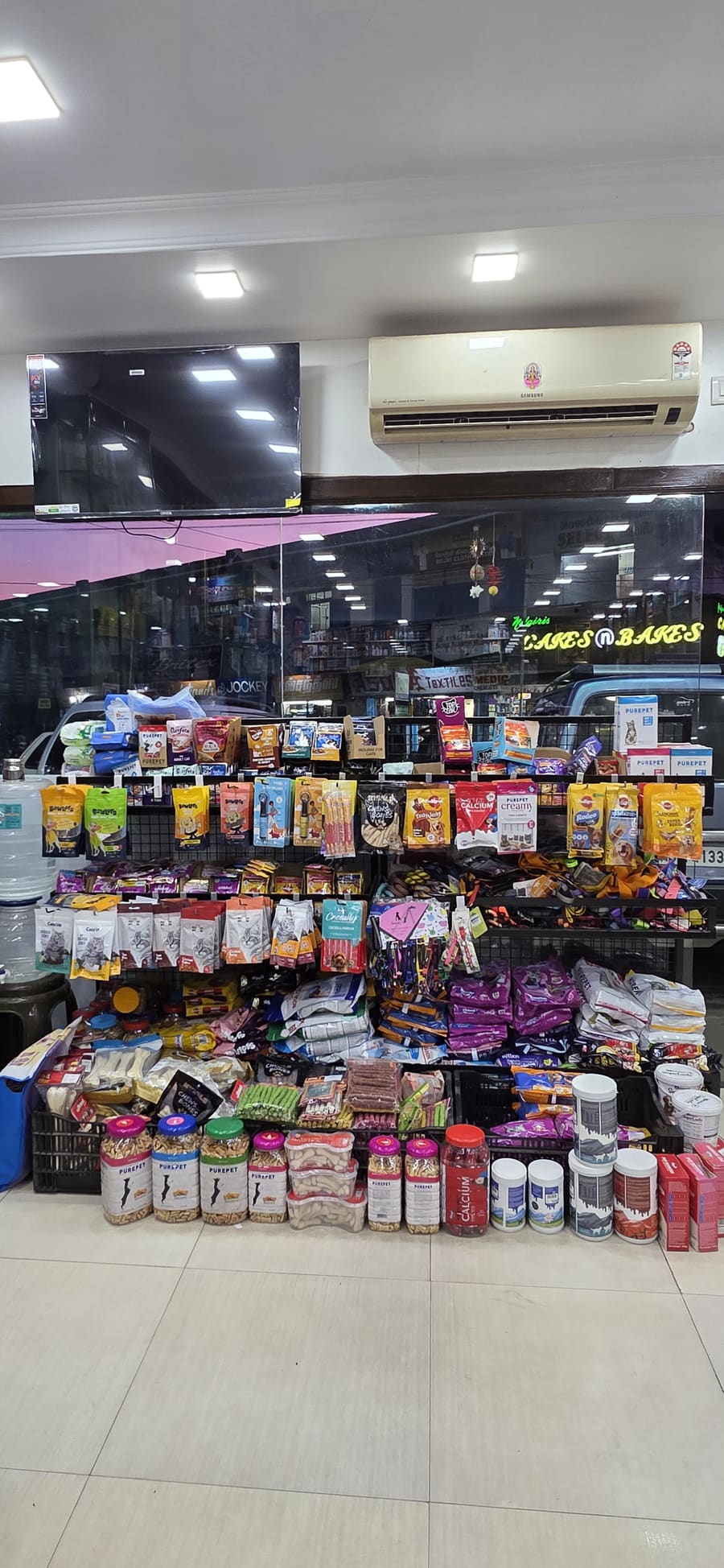 Pet care aisle stocked with dog and cat food, treats and supplements